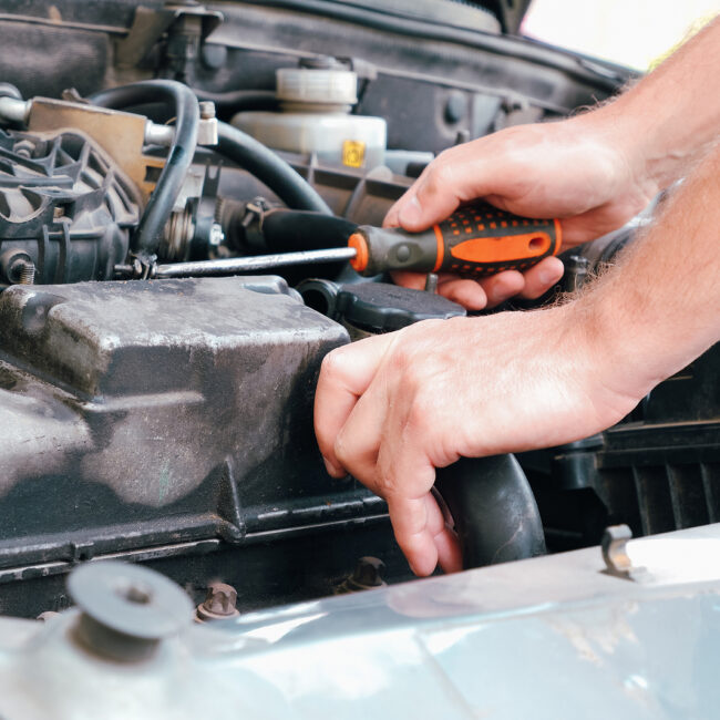 Auto Mechanic Working On Car Engine In Mechanics Garage. Repair