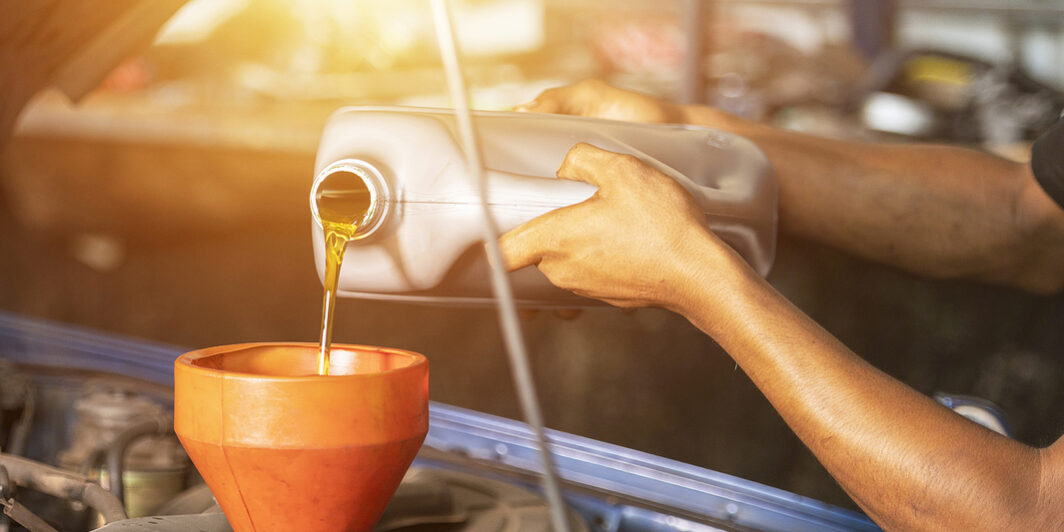 Old Car Oil Change Mechanic. Add New Oil To The Car. Pour Fresh