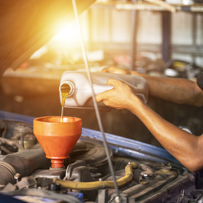 Old Car Oil Change Mechanic. Add New Oil To The Car. Pour Fresh