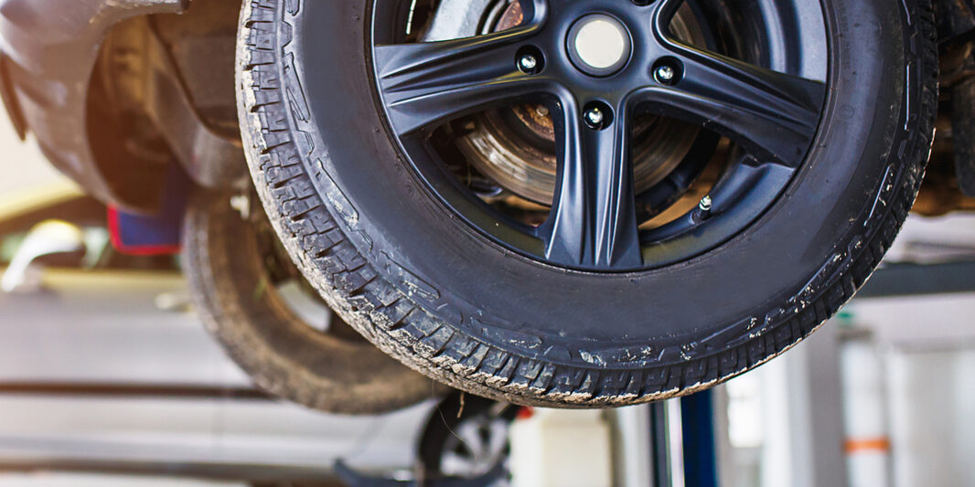 The Car Is Lifted For Repair On A Lift In A Car Service Station,