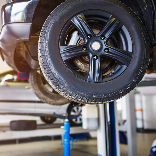 The Car Is Lifted For Repair On A Lift In A Car Service Station,