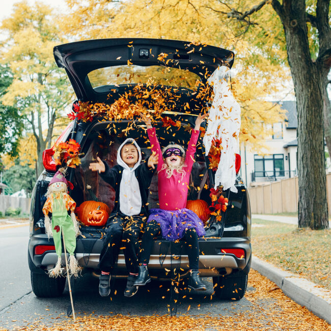 Trick Or Trunk. Children Celebrating Halloween In Trunk Of Car.