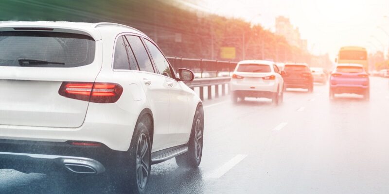 Wet Highway After Heavy Rain With Warm Sunset Evening Sun On Bac