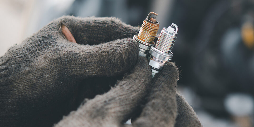 Spark Plug Replacement Work, Hand Of The Auto Mechanic Holding T