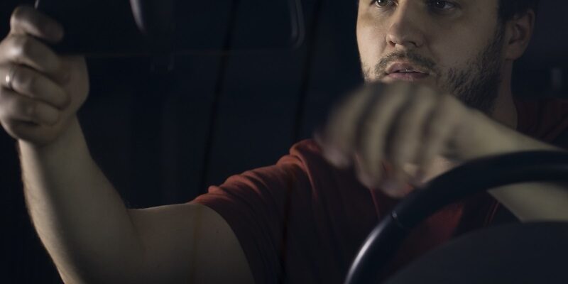 Unshaven Confident Serious Young Male Driver Sits At Steering Wh